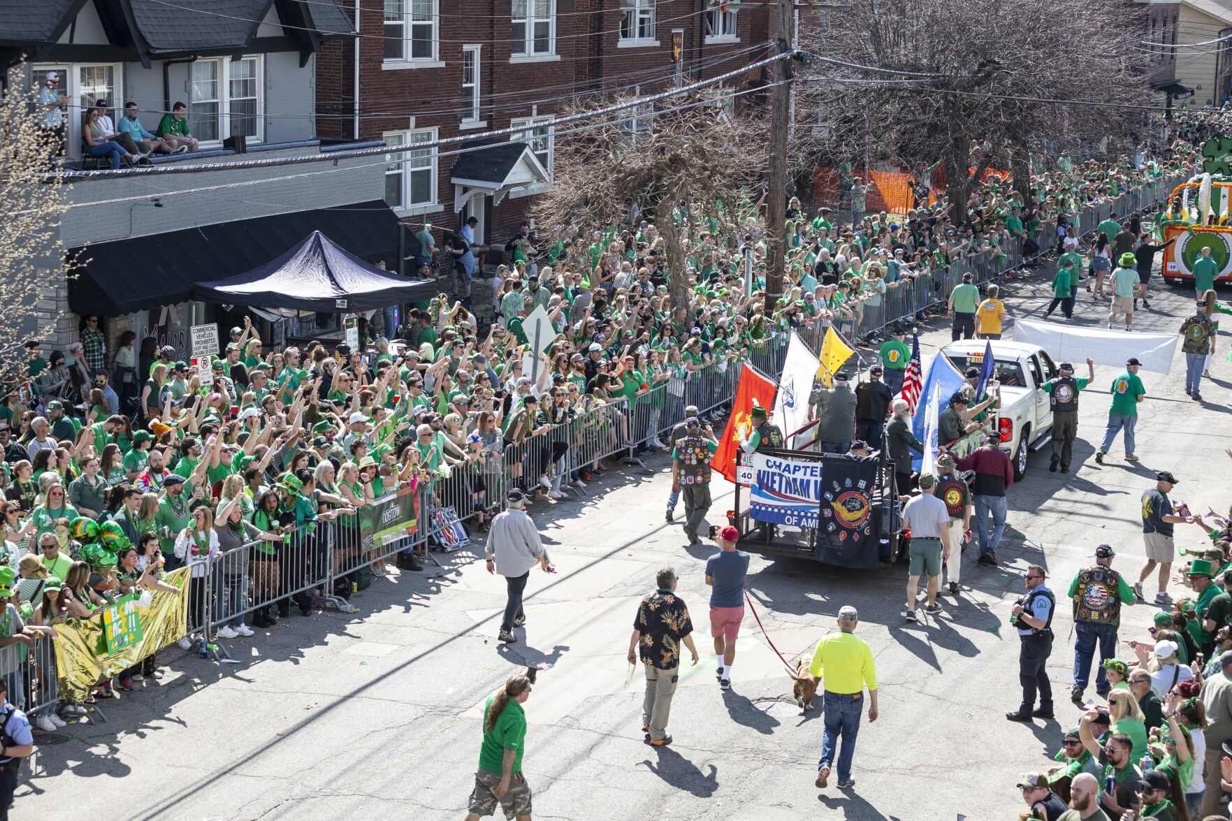 Revelers march and dance to the Ancient Order of Hibernians St. Patrick's Day Parade